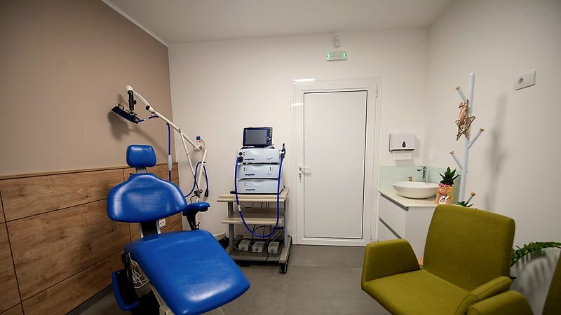 An assortment of medical instruments and a wrapped sterile package laid out on a stainless steel tray.